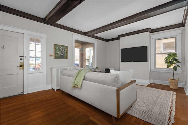 living room with beam ceiling, dark hardwood / wood-style flooring, and ornamental molding