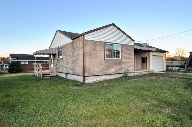 exterior space with a yard and a garage