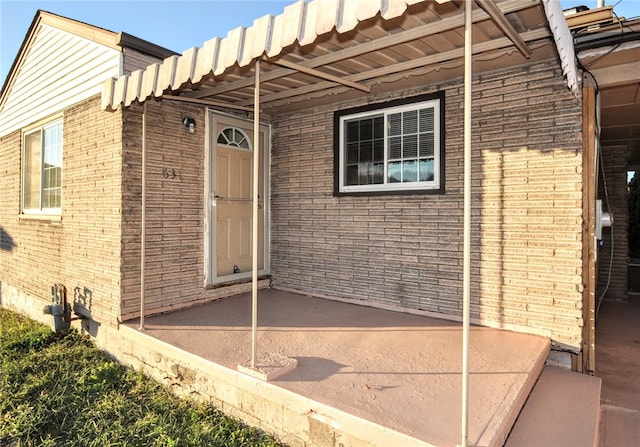 entrance to property featuring a patio