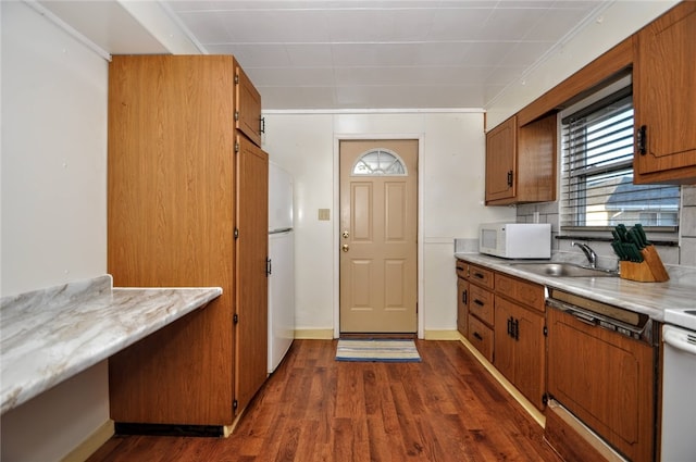 kitchen with sink, dark hardwood / wood-style floors, and white appliances