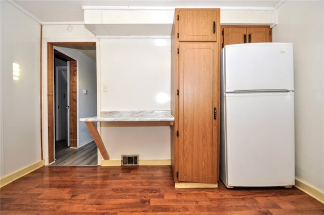 kitchen with dark hardwood / wood-style flooring and white refrigerator