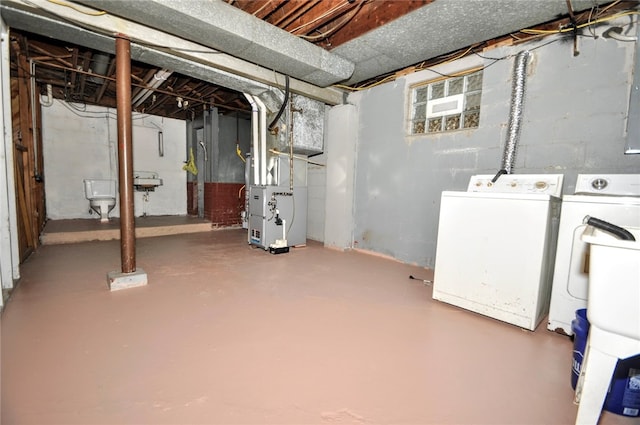 basement with washer and dryer and heating unit