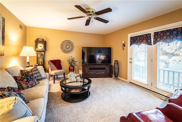 carpeted living room with ceiling fan