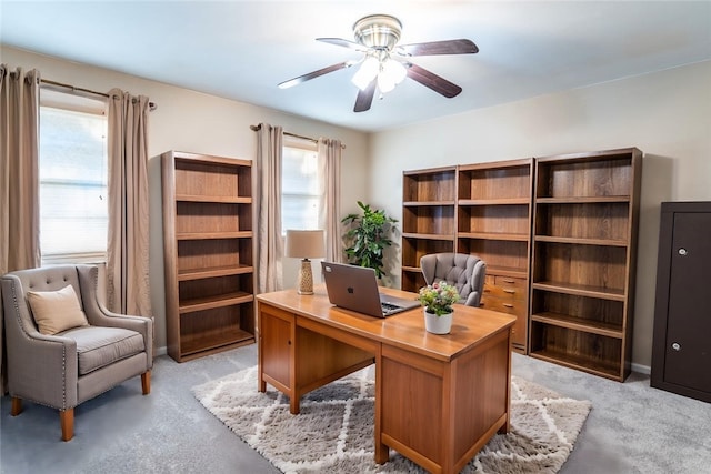 office featuring ceiling fan and light carpet