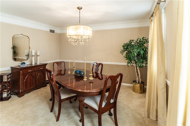 carpeted dining room featuring an inviting chandelier and ornamental molding