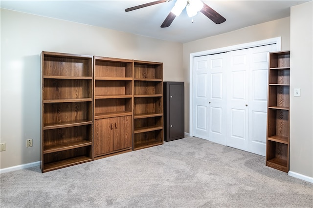 unfurnished bedroom with a closet, ceiling fan, and light colored carpet