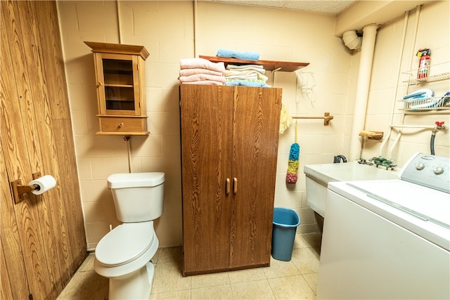 bathroom with vanity, toilet, and washer / dryer