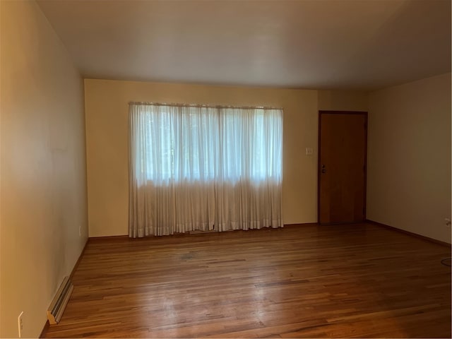 unfurnished room with hardwood / wood-style floors