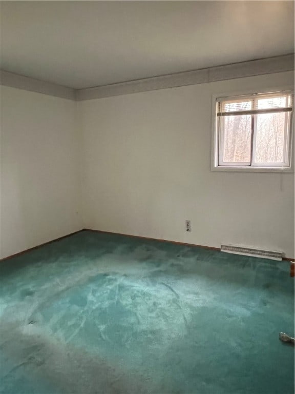 empty room with carpet and baseboard heating