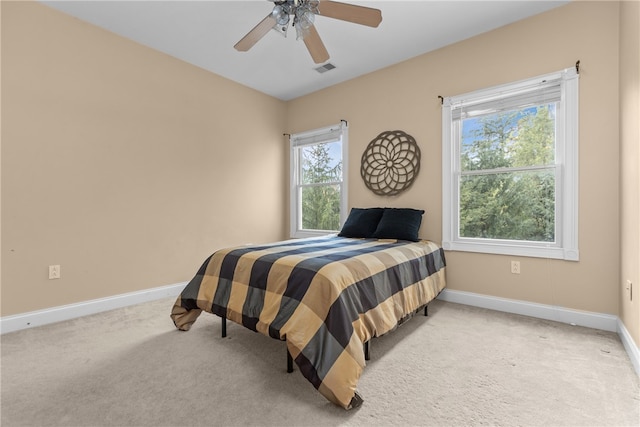 bedroom with ceiling fan and light carpet