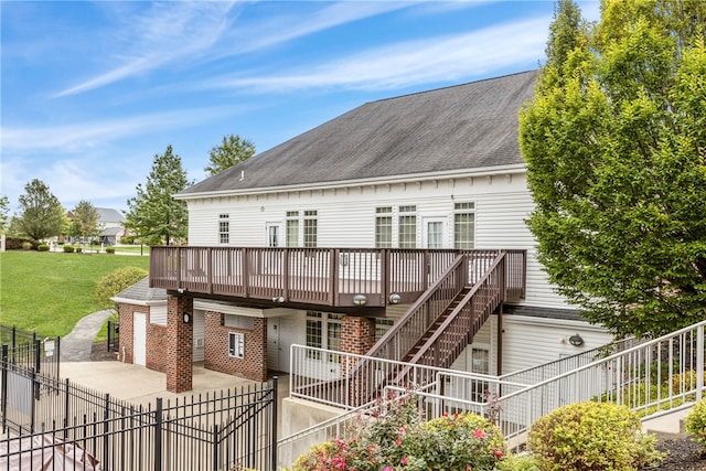 back of house featuring a yard and a wooden deck