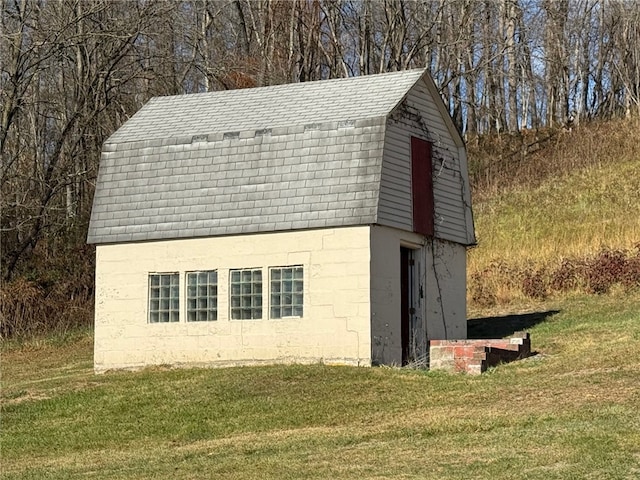 view of outdoor structure featuring a lawn