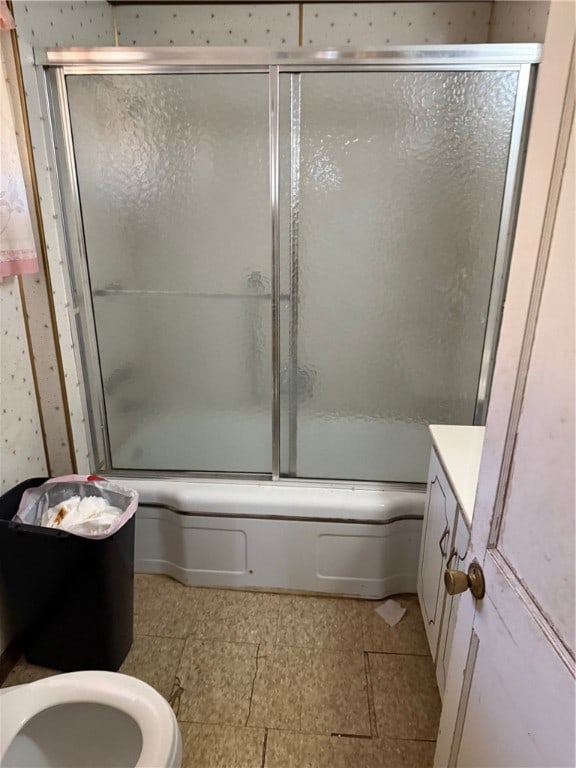 bathroom with shower / bath combination with glass door and vanity