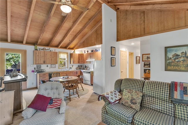 interior space with ceiling fan, beamed ceiling, high vaulted ceiling, light colored carpet, and wood ceiling