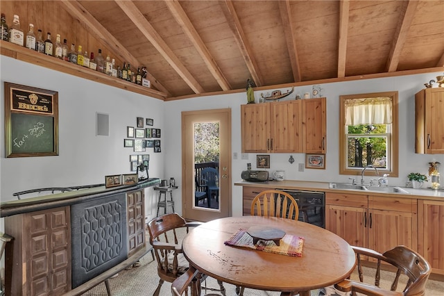 kitchen with wood ceiling, a healthy amount of sunlight, sink, and lofted ceiling with beams