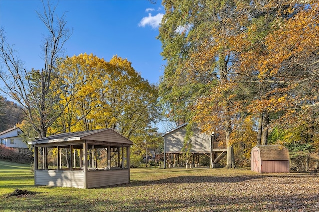 view of property's community with a yard and a storage shed