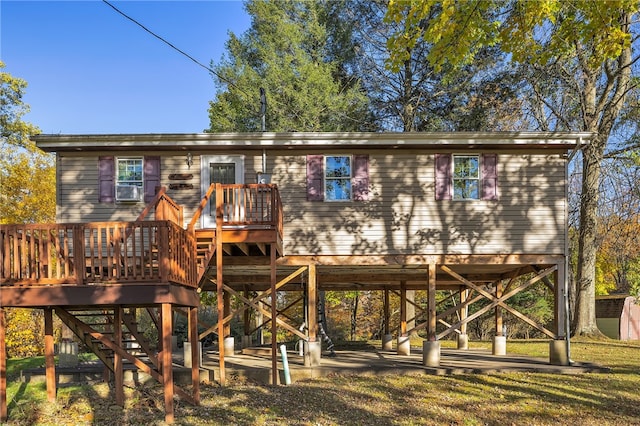 rear view of house with a yard and a deck