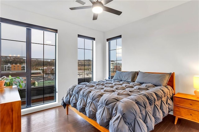 bedroom with ceiling fan and dark hardwood / wood-style floors