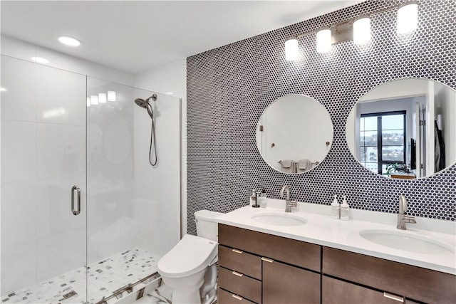 bathroom featuring vanity, a shower with shower door, tile walls, and toilet