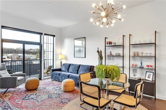 living room with dark hardwood / wood-style flooring and an inviting chandelier