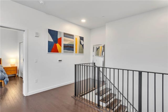 corridor with dark hardwood / wood-style flooring