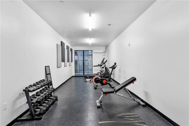 exercise area with a wall mounted air conditioner