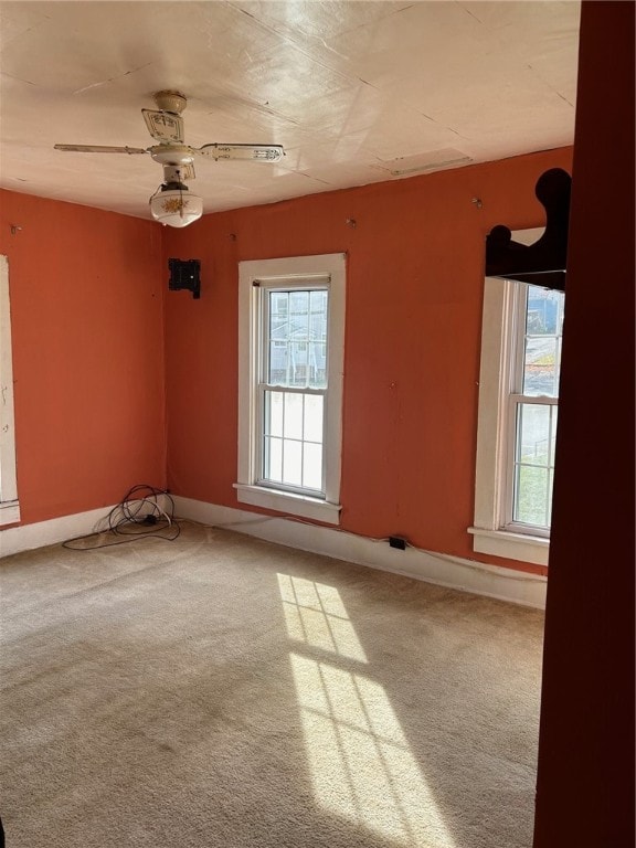 unfurnished room with ceiling fan and carpet floors