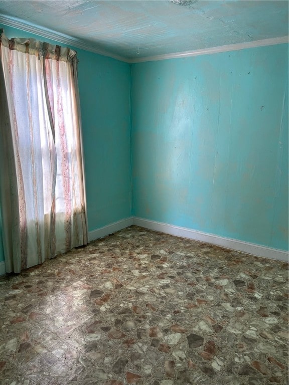 empty room featuring plenty of natural light and crown molding