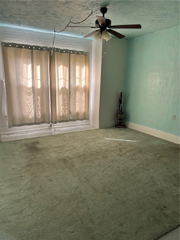 unfurnished room featuring ceiling fan, carpet floors, and a textured ceiling