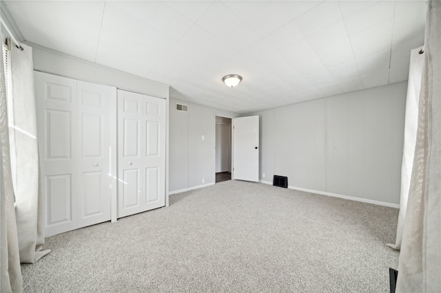 unfurnished bedroom with a closet and carpet flooring