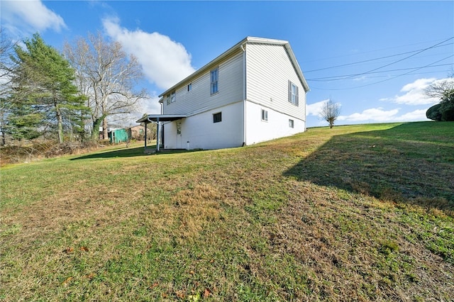 rear view of property featuring a yard