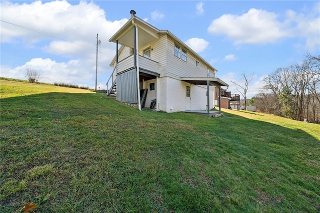 back of property featuring a lawn