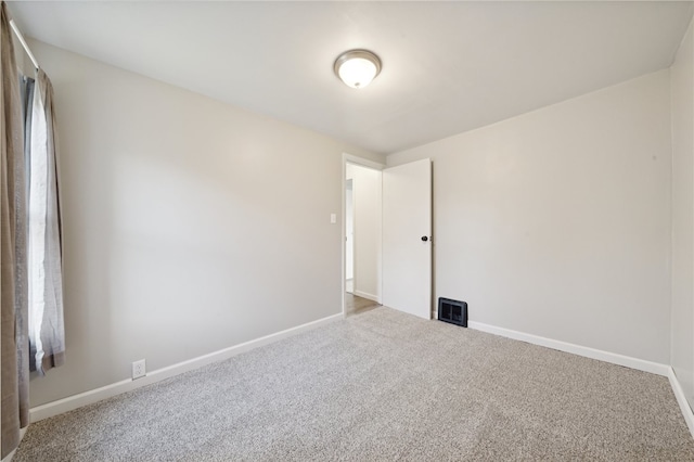 spare room with a wealth of natural light and carpet