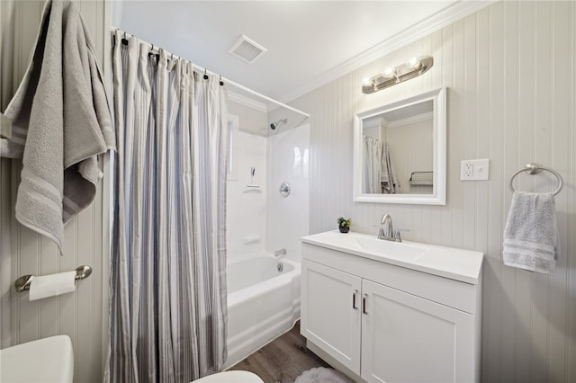 full bathroom with shower / bath combo, crown molding, wood-type flooring, toilet, and vanity