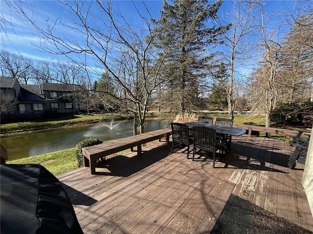 wooden terrace featuring a water view