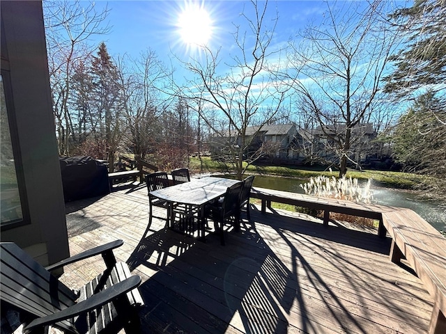 wooden deck with grilling area and a water view