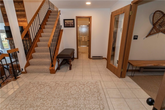 tiled entryway with a baseboard heating unit