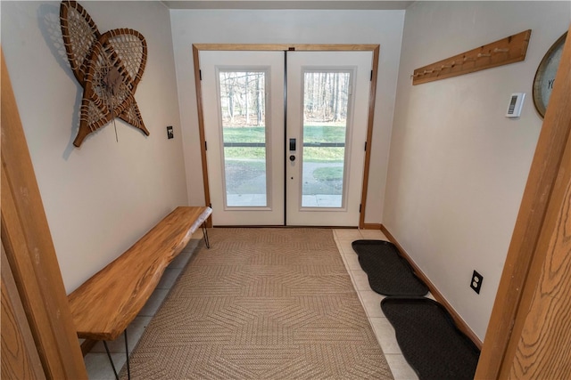 entryway with french doors and light tile patterned flooring