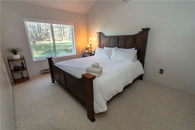 carpeted bedroom with vaulted ceiling and baseboard heating