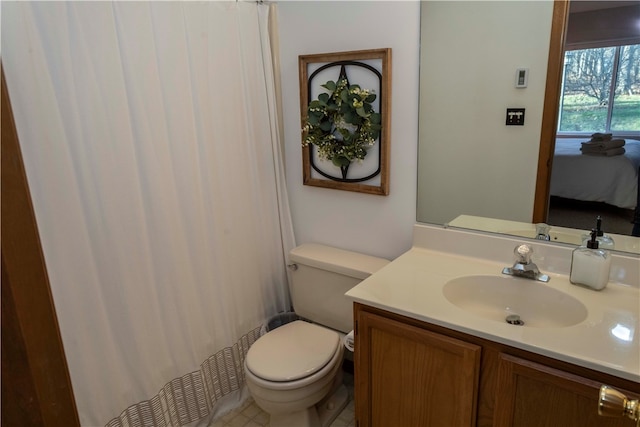 bathroom with tile patterned floors, vanity, and toilet