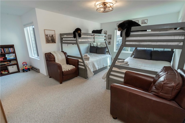 bedroom with carpet floors and a baseboard heating unit