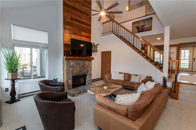 carpeted living room featuring a fireplace, plenty of natural light, high vaulted ceiling, and a baseboard radiator