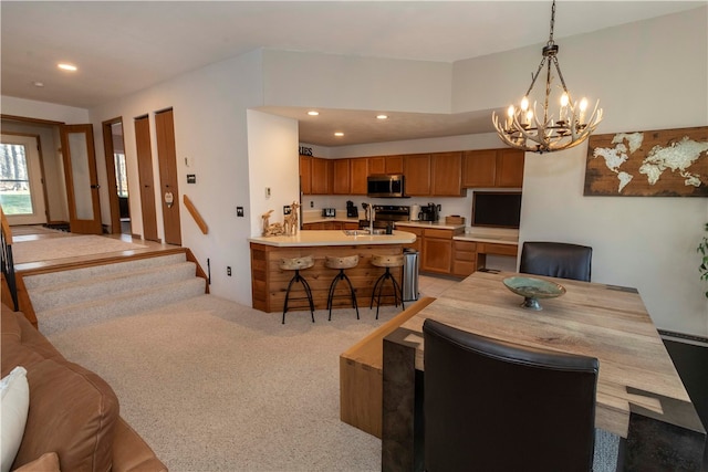 dining room with sink, light colored carpet, and an inviting chandelier