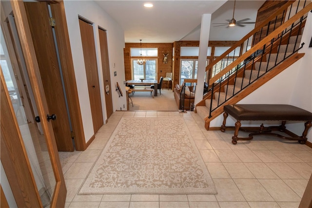 hall featuring light tile patterned floors and an inviting chandelier