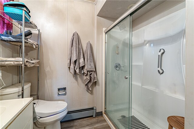 156 Sundust Rd, Nottingham, PA 15330 - bathroom featuring a baseboard heating unit, wood finished floors, vanity, and a shower stall
