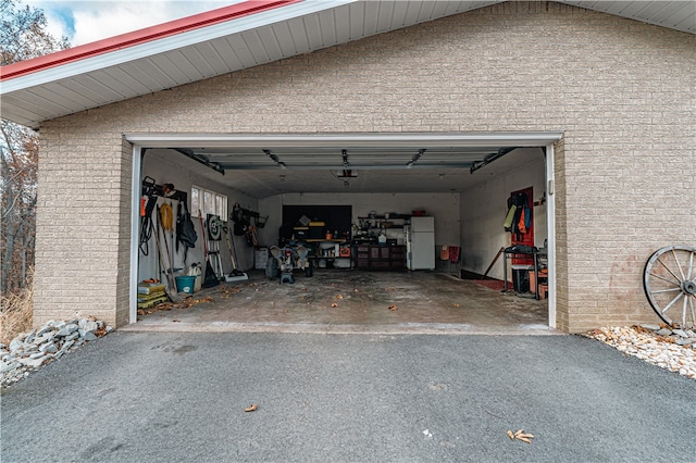 156 Sundust Rd, Nottingham, PA 15330 - garage featuring driveway, freestanding refrigerator, and a garage door opener