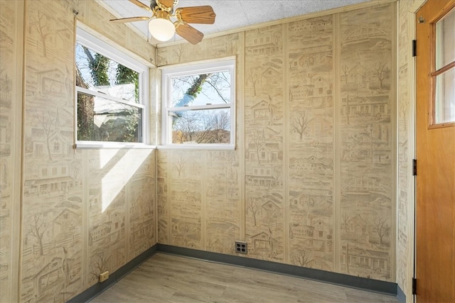 spare room with ceiling fan and hardwood / wood-style flooring