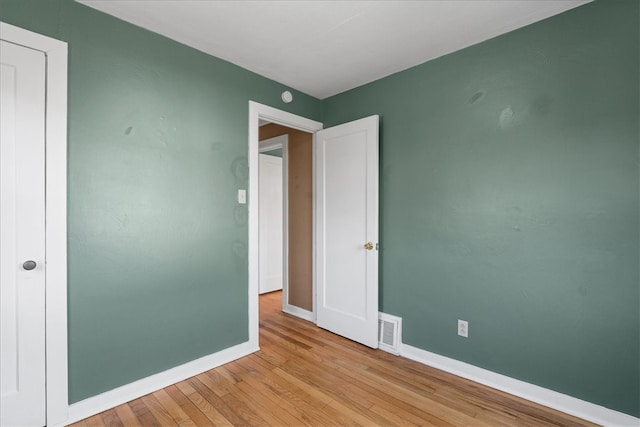 unfurnished room with light wood-type flooring