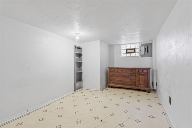 unfurnished room featuring electric panel and a textured ceiling