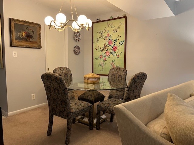 dining area featuring carpet flooring and an inviting chandelier